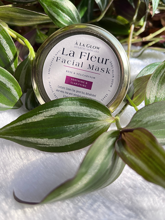 La Fleur Clay Facial Mask set in some leaves from a vine plant.
